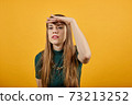 Portrait holding hand over eyes, looking at long distance confident determined 73213252