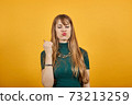 Excited young celebrating win, showing yes gesture, rejoicing success, good 73213259