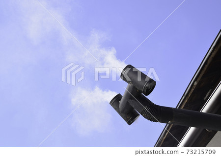 Wood-burning stove smoke coming out of the chimney Wood-burning stove smoke coming out of the chimney 73215709
