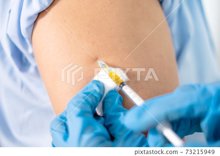 Female doctors vaccinated with syringes to prevent epidemics at hospitals, health care, and medical concepts Female doctors vaccinated with syringes to prevent epidemics at hospitals, health care, and medical concepts 73215949