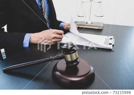 Professional male lawyers work at a law office There are scales, Scales of justice, judges gavel, and litigation documents. Concepts of law and justice Professional male lawyers work at a law office There are scales, Scales of justice, judges gavel, and litigation documents. Concepts of law and justice 73215999