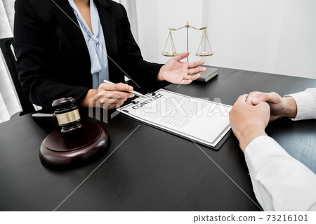 A woman lawyer or a judge counseling clients about judicial justice and prosecution with scales, judges gavel, legal documents legal services concept A woman lawyer or a judge counseling clients about judicial justice and prosecution with scales, judges gavel, legal documents legal services concept 73216101