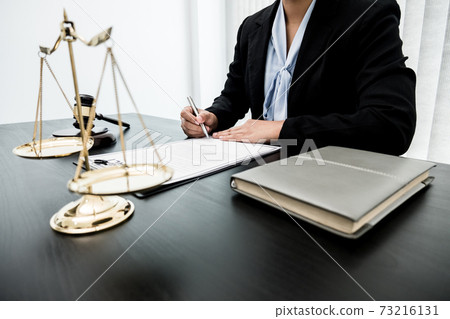 Professional women lawyers work at a law office There are scales, Scales of justice, judges gavel, and litigation documents. Concepts of law and justice 73216131
