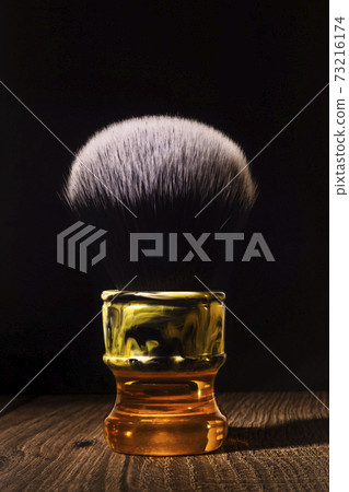 Posh shaving brush for classic shaving on a rustic background 73216174