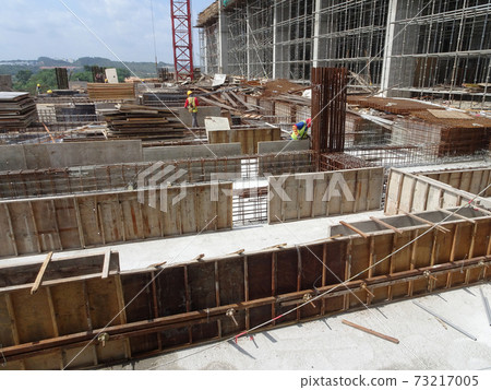 SEREMBAN, MALAYSIA -JULY 15, 2017: Construction workers fabricating timber form work mostly using timber and plywood at the construction site. SEREMBAN, MALAYSIA -JULY 15, 2017: Construction workers fabricating timber form work mostly using timber and plywood at the construction site. 73217005