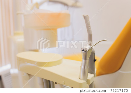 View of modern empty dental surgery yellow chair. View of modern empty dental surgery yellow chair. 73217170