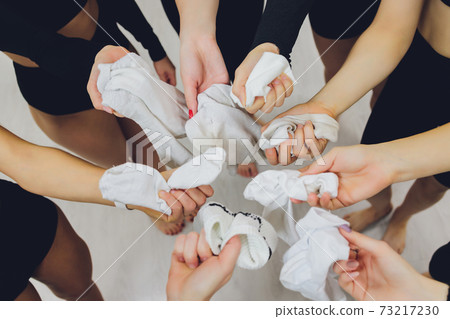 female hand close-up. dirty white socks short supply. female hand close-up. dirty white socks short supply. 73217230