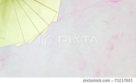 Blank golden cards stacked together in a fan shape at the top left corner, with pink marble background and copy space in the middle. Blank golden cards stacked together in a fan shape at the top left corner, with pink marble background and copy space in the middle. 73217601
