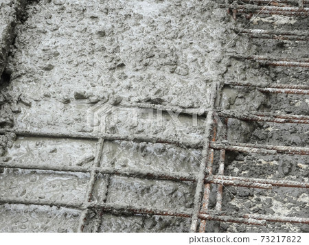 MALACCA, MALAYSIA -JULY 26, 2016: The wet concrete poured on a steel reinforcement bar to form strong floor slabs called reinforce concrete floor slab. MALACCA, MALAYSIA -JULY 26, 2016: The wet concrete poured on a steel reinforcement bar to form strong floor slabs called reinforce concrete floor slab. 73217822