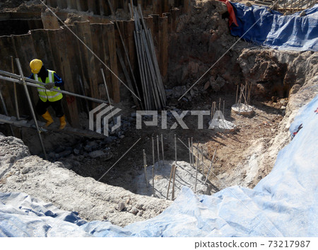MALACCA, MALAYSIA -DECEMBER 07, 2016: Construction activity by construction workers for foundation work inside the sheet pile cofferdam retaining wall area.  73217987