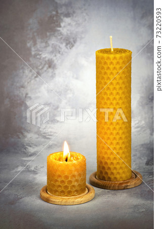 two yellow beeswax candles 73220593