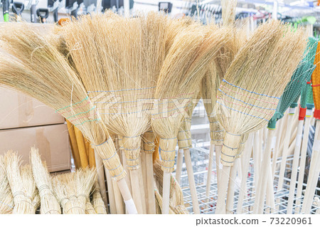 brooms in the store close-up. as background brooms in the store close-up. as background 73220961