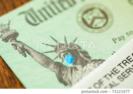 United States IRS Stimulus Check with Statue of Liberty Wearing Medical Face Mask United States IRS Stimulus Check with Statue of Liberty Wearing Medical Face Mask 73221077