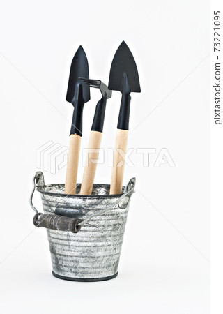 garden shovel, rake and a metal bucket isolated 73221095
