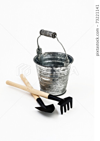 garden shovel, rake and a metal bucket isolated 73221141