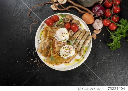 Crepe with grilled chicken sausages, mushrooms, cherry tomatoes and poached egg. A hot continental breakfast. Crepe with grilled chicken sausages, mushrooms, cherry tomatoes and poached egg. A hot continental breakfast. 73221404