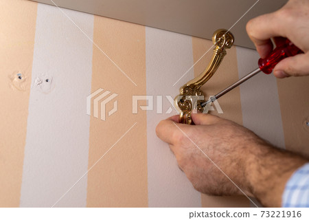 Installing a wardrobe hook 73221916