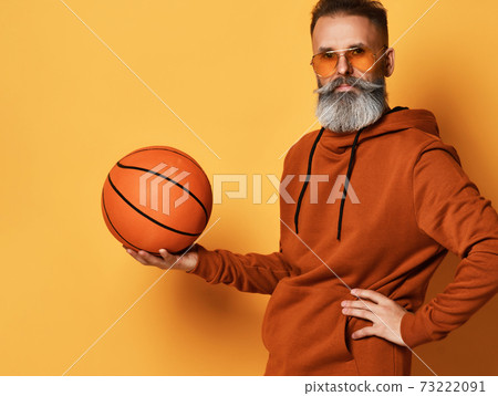 Serious bearded man in sunglasses, hoodie holding 73222091