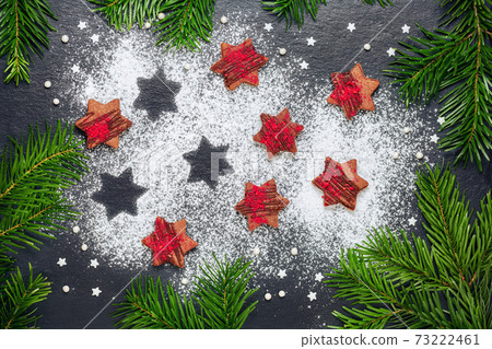 christmas cookies chocolate stars with raspberry crunches on slate table 73222461