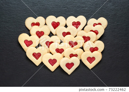 christmas cookies hearts with strawberry jam on slate table christmas cookies hearts with strawberry jam on slate table 73222462
