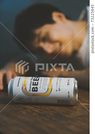 A young man who drinks canned beer and gets drunk A young man who drinks canned beer and gets drunk 73225645
