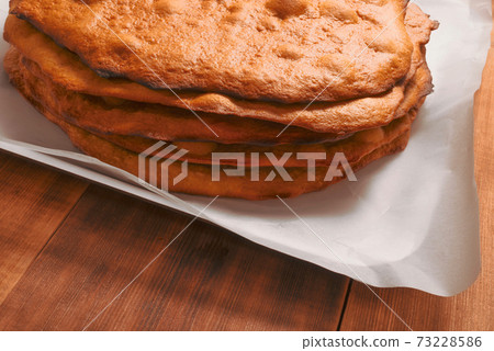 Empty cake crust on wooden rural kitchen table. Bakery thematic background. Empty cake crust on wooden rural kitchen table. Bakery thematic background. 73228586