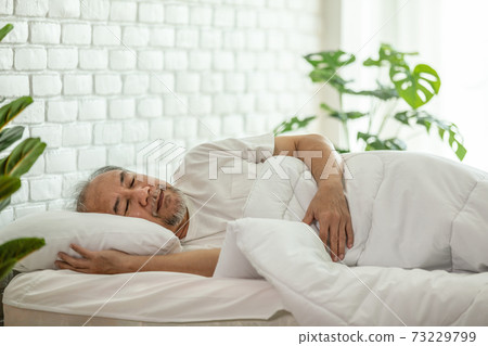 Asian Elderly man close eyes smile sleep and sweet dream on bed in bedroom in the morning feeling so relax and comfortable,Healthcare and Sleep Concept 73229799