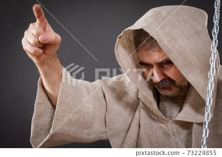 Halloween concept. The judge of the holy inquisition pronounces judgment on the sinner 73229855