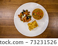 Rice with Panaeng Curry with Pork, .Stir Fried Chicken with Cashew Nuts and Omelette on wooden table from Top, Thai traditional cuisine food..Pork Panang, savory red curry paste pork and coconut milk 73231526