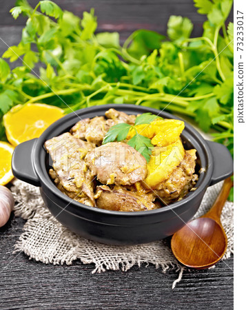 Liver with oranges in pan on wooden board 73233017