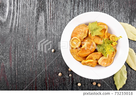 Mushrooms salted in plate on black board top Mushrooms salted in plate on black board top 73233018