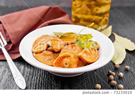 Mushrooms salted in plate on black board Mushrooms salted in plate on black board 73233019