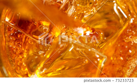 Ice Cube falling into Glass of Whisky Ice Cube falling into Glass of Whisky 73233723