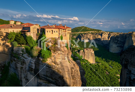 Cliff top Varlaam monastery, evening sun, Meteora, Greece, typical landscape of rocks. Moni Agias Varvaras Roussanou nunnery. UNESCO World Heritage Cliff top Varlaam monastery, evening sun, Meteora, Greece, typical landscape of rocks. Moni Agias Varvaras Roussanou nunnery. UNESCO World Heritage 73233898