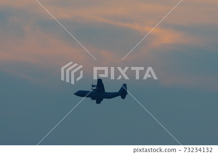 C-130 Hercules flying in the evening 73234132