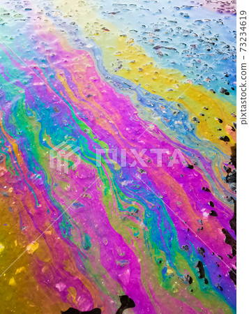 Colored texture of oil products on the asphalt in the rain. Colored texture of oil products on the asphalt in the rain. 73234619
