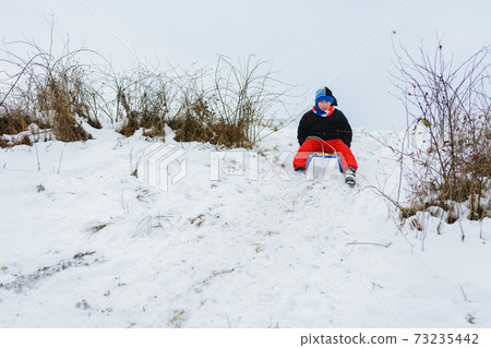 for a sledge down the boy in red pants is very happy for a sledge down the boy in red pants is very happy 73235442