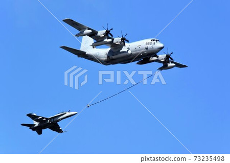 U.S. Marine Corps KC-130 aerial refueling aircraft and FA-18 fighter-bomber demonstrating aerial refueling U.S. Marine Corps KC-130 aerial refueling aircraft and FA-18 fighter-bomber demonstrating aerial refueling 73235498
