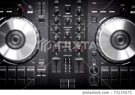 DJ controller close up view in live performance night club dance music. Dj. DJ controller close up view in live performance night club dance music. Dj. 73235675