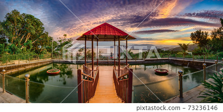 Pavilion on the pond at sunset. Panorama 73236146