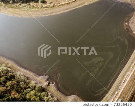 Aerial view with the drone of a large pond 73236430