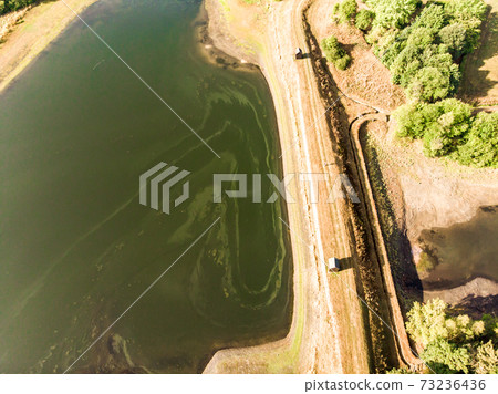 Aerial view of the dam between two artificial ponds 73236436