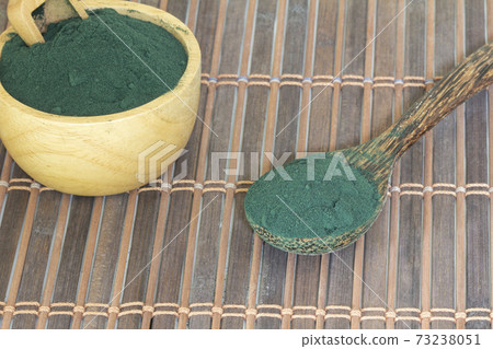Organic spirulina algae powder in a bowl Organic spirulina algae powder in a bowl 73238051