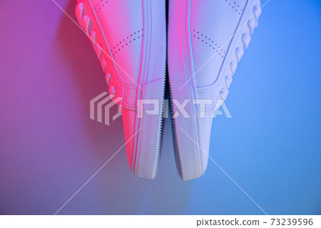 Pair of sneakers on color background, top view Pair of sneakers on color background, top view 73239596