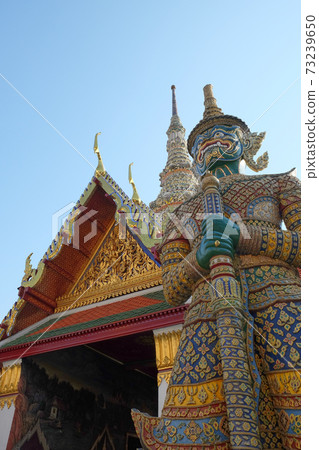 Patterned sculpture of a demonic warrior near a Buddhist temple. Patterned sculpture of a demonic warrior near a Buddhist temple. 73239650