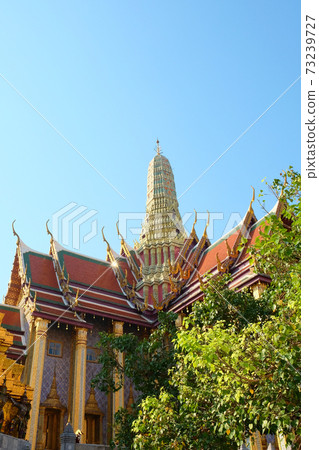 Temple of the Emerald Buddha on a sunny day. Sample of religious architectural art of Southeast Asia. 73239727
