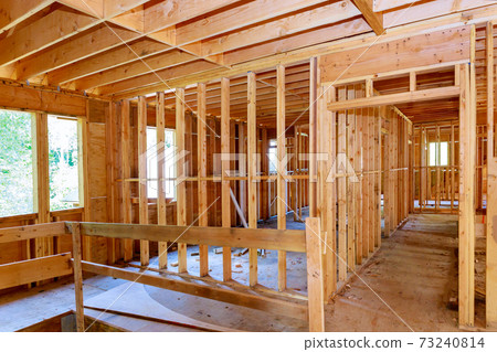 Unfinished of interior view of a house residential construction framing against 73240814