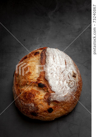 Sourdough bread with mixed fruits and nuts on dark cement background. 73240867