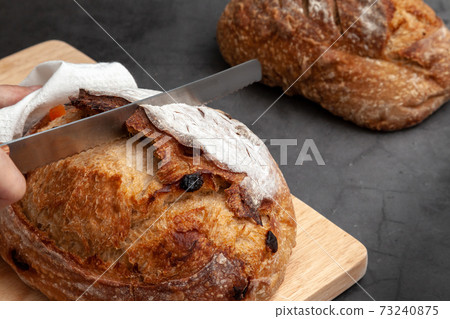 Sourdough bread with mixed fruits and nuts on dark cement background. 73240875