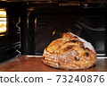 Baking sourdough bread in an oven. 73240876
